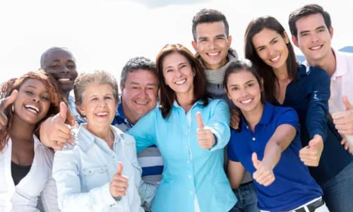 Diverse group of people with thumbs up.